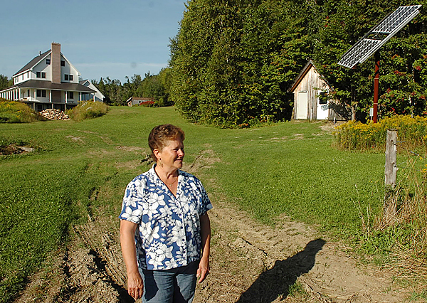 Powered by solar and wind energy, Patty Hill's Eagle Lake home is completely "off the grid". The solar panels, on right, along with wind turbines, generate energy which is then stored in batteries until it is needed to power the home's lights, appliances, television, computer, and anything else that requires electricity. Buy Photo Powered by solar and wind energy, Patty Hill's Eagle Lake home is completely "off the grid". The solar panels, on right, along with wind turbines, generate energy which is then stored in batteries until it is needed to power the home's lights, appliances, television, computer, and anything else that requires electricity. Buy Photo