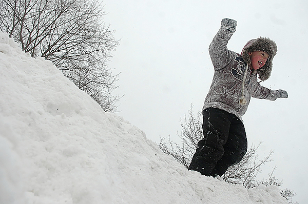 Nick Fournier, 5, of Bangor readies to leap from a snowbank while enjoying a day off from school due to a storm Monday. Nick Fournier, 5, of Bangor readies to leap from a snowbank while enjoying a day off from school due to a storm Monday.