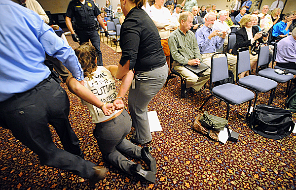 One of the protesters is taken out of the room during a meeting of the Land Use Regulatory Commission at Ramada Inn in Bangor Wednesday afternoon, Sept. 23, 2009. The commission voted to allow Plum Creek Timber Co. to develop parts of the Moosehead Lake region. (Bangor Daily News/Gabor Degre) One of the protesters is taken out of the room during a meeting of the Land Use Regulatory Commission at Ramada Inn in Bangor Wednesday afternoon, Sept. 23, 2009. The commission voted to allow Plum Creek Timber Co. to develop parts of the Moosehead Lake region. (Bangor Daily News/Gabor Degre)