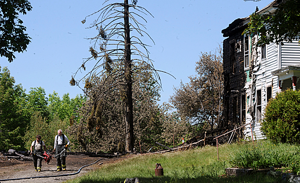 Firefighters gather their equipment after a fire in LaGrange Wednesday morning that burned a second vacant building belonging to LaGrange resident John Drake within the last 24 hours. Investigators from the State Fire Marshal's Office have said both fires are arson.(BANGOR DAILY NEWS PHOTO BY GABOR DEGRE)
CAPTION
Firefighters gather their equipment after a fire in Lagrange Wednesday morning, June 17, 2009. It was the second building that burned in a 24-hour period that was owned by John Drake of Lagrange. Investigators from the State Fire Marshal's Office have said that the fires were set by an arsonist. (Bangor Daily News/Gabor Degre) Firefighters gather their equipment after a fire in LaGrange Wednesday morning that burned a second vacant building belonging to LaGrange resident John Drake within the last 24 hours. Investigators from the State Fire Marshal's Office have said both fires are arson.(BANGOR DAILY NEWS PHOTO BY GABOR DEGRE)
CAPTION
Firefighters gather their equipment after a fire in Lagrange Wednesday morning, June 17, 2009. It was the second building that burned in a 24-hour period that was owned by John Drake of Lagrange. Investigators from the State Fire Marshal's Office have said that the fires were set by an arsonist. (Bangor Daily News/Gabor Degre)