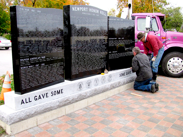 Blain Creighton of Newport Monument (kneeling) and Jim Elias of Elias Monuments of Madison install the last section of a three-piece memorial to honor veterans from Newport who served during wartime. BANGOR DAILY NEWS PHOTO BY CHRISTOPHER COUSINS Blain Creighton of Newport Monument (kneeling) and Jim Elias of Elias Monuments of Madison install the last section of a three-piece memorial to honor veterans from Newport who served during wartime. BANGOR DAILY NEWS PHOTO BY CHRISTOPHER COUSINS