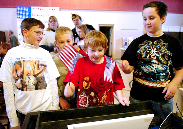 Jake Baker, 8, (from left), Ethan Neal, 10, and Kyle Estes, 10, talk to Jake's father Tech Sgt. Joe Baker and Master Chief Dennis Wellman, who are both currently serving in Iraq, via Skype during a special Veterans Day ceremony at the Marion C. Cook School in Lagrange on Monday, Nov. 9, 2009. BANGOR DAILY NEWS PHOTO BY BRIDGET BROWN Jake Baker, 8, (from left), Ethan Neal, 10, and Kyle Estes, 10, talk to Jake's father Tech Sgt. Joe Baker and Master Chief Dennis Wellman, who are both currently serving in Iraq, via Skype during a special Veterans Day ceremony at the Marion C. Cook School in Lagrange on Monday, Nov. 9, 2009. BANGOR DAILY NEWS PHOTO BY BRIDGET BROWN