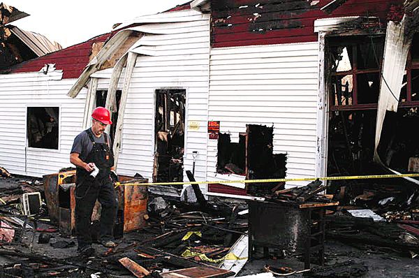 Gary P. Simard, a certified fire investigator for Fire & Explosion Investigators, Inc. of Norway, Maine searches on Monday, November 9, 2009 for clues, as to what started the blaze that destroyed the Lincoln New Print Services building at 78 West Broadway last week. BANGOR DAILY NEWS PHOTO BY NICK SAMBIDES JR. Gary P. Simard, a certified fire investigator for Fire & Explosion Investigators, Inc. of Norway, Maine searches on Monday, November 9, 2009 for clues, as to what started the blaze that destroyed the Lincoln New Print Services building at 78 West Broadway last week. BANGOR DAILY NEWS PHOTO BY NICK SAMBIDES JR.