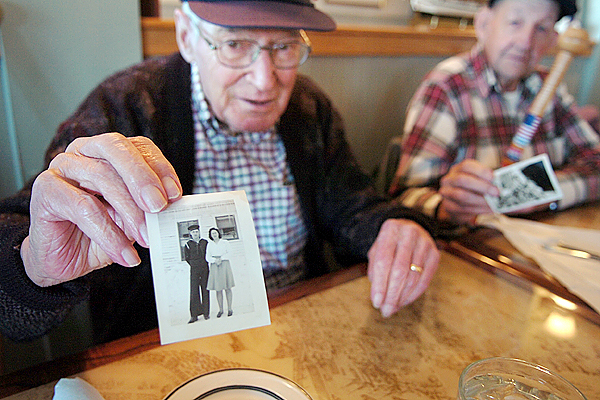 Keith Dow of Hampden shares a photo of him and his wife Barbara taken during the time of his Navy service in WWII at the Muddy Rudder in Brewer on Veterans Day Wednesday, Nov. 11, 2009. Dow along with friends Frank Ring (background) of Orrington, and Keith Gove of Hampden, each brought photographs of themselves from the era of their service to share with one another over lunch. (Bangor Daily News/Bridget Brown) Keith Dow of Hampden shares a photo of him and his wife Barbara taken during the time of his Navy service in WWII at the Muddy Rudder in Brewer on Veterans Day Wednesday, Nov. 11, 2009. Dow along with friends Frank Ring (background) of Orrington, and Keith Gove of Hampden, each brought photographs of themselves from the era of their service to share with one another over lunch. (Bangor Daily News/Bridget Brown)