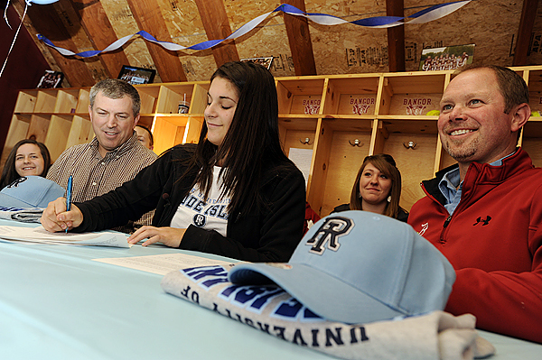 Flanked by assistant coach Doug Whitney, left, and head coach Don Stanhope as well as teammates, Bangor High School softball standout Sam Bedore, center, signs a National Letter of Intent toplay for the University of Rhode Island Rams during Thursday afternoon's press conference in the school's press box. Flanked by assistant coach Doug Whitney, left, and head coach Don Stanhope as well as teammates, Bangor High School softball standout Sam Bedore, center, signs a National Letter of Intent toplay for the University of Rhode Island Rams during Thursday afternoon's press conference in the school's press box.