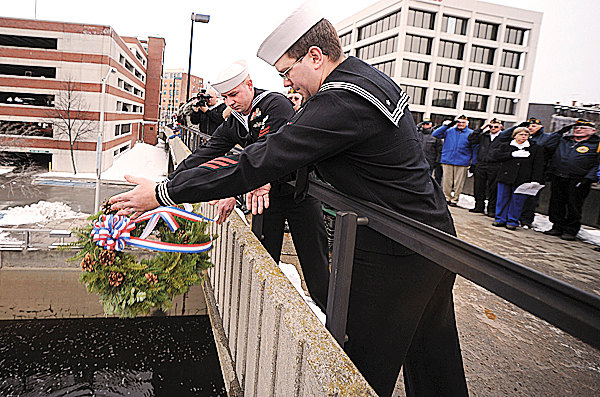 Members of the Navy Operational Support Center in Bangor, Petty officer 3rd Class Ryan Pelkey, foreground, and Petty Officer 2nd Class, Arthur Ullmann drop a wreath from the footbridge over the Kenduskeag Stream in downtown Bangor on Monday, December 7, 2009, as part of the observance of the 68th anniversary of the Japanese bombing of military bases in the Hawaiian islands in 1941. Members of the Navy Operational Support Center in Bangor, Petty officer 3rd Class Ryan Pelkey, foreground, and Petty Officer 2nd Class, Arthur Ullmann drop a wreath from the footbridge over the Kenduskeag Stream in downtown Bangor on Monday, December 7, 2009, as part of the observance of the 68th anniversary of the Japanese bombing of military bases in the Hawaiian islands in 1941.