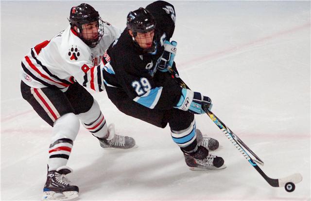 University of Maine junior Tanner House (29) controls the puck ahead of Northeastern sophomore J.P. Maley in the first period of Saturday's game at the Alfond Arena in Orono. Buy Photo University of Maine junior Tanner House (29) controls the puck ahead of Northeastern sophomore J.P. Maley in the first period of Saturday's game at the Alfond Arena in Orono. Buy Photo