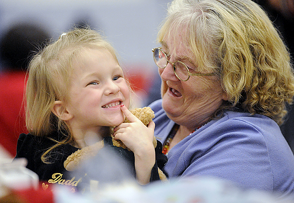 Clutching her stuffed toy bear, three-year-old Ashley Smith of Brewer beams a smile to other family members while sitting in the lap of her great-grandmother Caroline Laird of Bangor during Manna's Christmas dinner at Bangor Parks and Rec Friday, December 25,2009. (Bangor Daily News/John Clarke Russ) Clutching her stuffed toy bear, three-year-old Ashley Smith of Brewer beams a smile to other family members while sitting in the lap of her great-grandmother Caroline Laird of Bangor during Manna's Christmas dinner at Bangor Parks and Rec Friday, December 25,2009. (Bangor Daily News/John Clarke Russ)