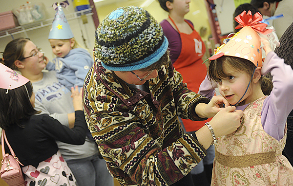 Maayan Freedberg (cq), 6 of Bangor gets help from her mom, Naomi Freedberg, as they strap on her self-crafted New Years party hat during Thursday afternoon's noisemaker and hat making party at Maine Discovery Museum. Behind them are Mikayla Smith (lower left) 9, of Brewer and Danielle Rideout holding her two-year-old daughter Lily Rideout. New Years events took place across the region to usher in 2010. BANGOR DAILY NEWS PHOTO BY JOHN CLARKE RUSS Maayan Freedberg (cq), 6 of Bangor gets help from her mom, Naomi Freedberg, as they strap on her self-crafted New Years party hat during Thursday afternoon's noisemaker and hat making party at Maine Discovery Museum. Behind them are Mikayla Smith (lower left) 9, of Brewer and Danielle Rideout holding her two-year-old daughter Lily Rideout. New Years events took place across the region to usher in 2010. BANGOR DAILY NEWS PHOTO BY JOHN CLARKE RUSS