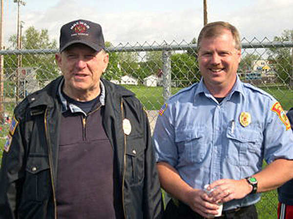 Richard "Dick"Dore, who retired last week after 40 years on on-call service with Brewer Fire Department, stands with his son, Assistant Fire Chief Chris Dore. COURTESY of LARRY DOUGHTY. 2 col max Richard "Dick"Dore, who retired last week after 40 years on on-call service with Brewer Fire Department, stands with his son, Assistant Fire Chief Chris Dore. COURTESY of LARRY DOUGHTY. 2 col max