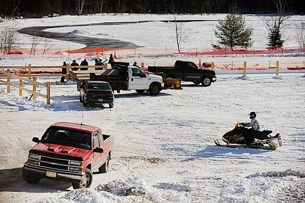 A member of the East Branch Sno-Rovers Club rides his snowmobile past the construction site of the club's soon-to-be-completed 2400-foot-long ice snowmobile racing track near the snowmobile clubhouse in Medway. Photographed January 9, 2010. BANGOR DAILY NEWS PHOTO BY JOHN CLARKE RUSS A member of the East Branch Sno-Rovers Club rides his snowmobile past the construction site of the club's soon-to-be-completed 2400-foot-long ice snowmobile racing track near the snowmobile clubhouse in Medway. Photographed January 9, 2010. BANGOR DAILY NEWS PHOTO BY JOHN CLARKE RUSS
