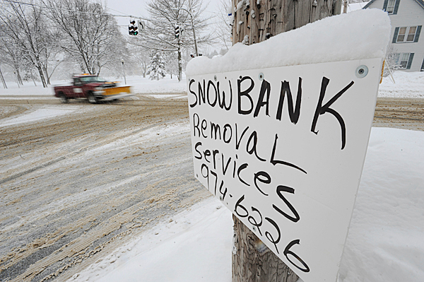 A sign advertising snow removal adorns a telephone pole at the corner of Stillwater Avenue and Broadway in Bangor on Wednesday, Jan.20, 1020. Area schools were canceled and traffic slowed around town as residents dug out from Tuesday night's snow storm. BANGOR DAILY NEWS PHOTO BY KEVIN BENNETT A sign advertising snow removal adorns a telephone pole at the corner of Stillwater Avenue and Broadway in Bangor on Wednesday, Jan.20, 1020. Area schools were canceled and traffic slowed around town as residents dug out from Tuesday night's snow storm. BANGOR DAILY NEWS PHOTO BY KEVIN BENNETT