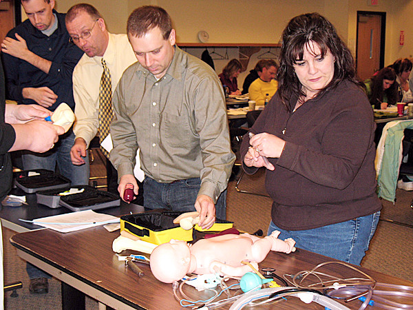 Presque Isle -- Rita Zbylut, right, an emergency room flight nurse at Cary Medical Center, and Scott Michaud, clinical coordinator of NMCC's emergency medical services program, go over pediatric resuscitation techniques as part of the CCEMTP program, while Daryl Boucher, NMCC EMS coordinator, looks on. Twenty students from throughout the state and nation are in the process of completing the advanced training at NMCC. The 88-hour program is geared toward helping medical professionals understand and meet the special needs of critical care patients during transport. (PHOTO COURTESY OF NMCC) LYNDS STORY Presque Isle -- Rita Zbylut, right, an emergency room flight nurse at Cary Medical Center, and Scott Michaud, clinical coordinator of NMCC's emergency medical services program, go over pediatric resuscitation techniques as part of the CCEMTP program, while Daryl Boucher, NMCC EMS coordinator, looks on. Twenty students from throughout the state and nation are in the process of completing the advanced training at NMCC. The 88-hour program is geared toward helping medical professionals understand and meet the special needs of critical care patients during transport. (PHOTO COURTESY OF NMCC) LYNDS STORY