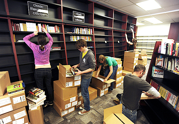 Employees of Bull Moose Music in Bangor open boxes of books and stock new fixtures with them on Wednesday, Feb. 11, 2010. BANGOR DAILY NEWS PHOTO BY KEVIN BENNETT Employees of Bull Moose Music in Bangor open boxes of books and stock new fixtures with them on Wednesday, Feb. 11, 2010. BANGOR DAILY NEWS PHOTO BY KEVIN BENNETT