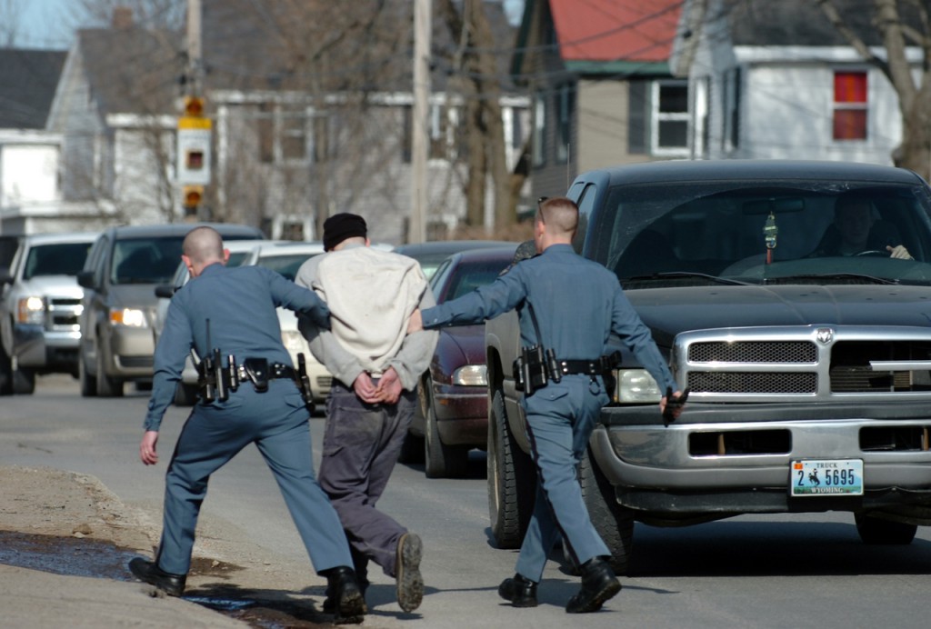 Maine State Police troopers walk Christopher Norris, 28, of Bangor across Broadway in Bangor after his arrest Tuesday morning, Feb. 16, 2010 near St. Joseph Hospital. According to Sgt. Sean Hashey, Norris was riding as a passenger in a car when the driver was stopped for a motor vehicle violation and Norris fled from the vehicle. Norris was arrested for outstanding warrants and will likely be charged with criminal threatening according to Hashey because "he claimed that he had a firearm and that he would shoot." (Bangor Daily News/Bridget Brown) Maine State Police troopers walk Christopher Norris, 28, of Bangor across Broadway in Bangor after his arrest Tuesday morning, Feb. 16, 2010 near St. Joseph Hospital. According to Sgt. Sean Hashey, Norris was riding as a passenger in a car when the driver was stopped for a motor vehicle violation and Norris fled from the vehicle. Norris was arrested for outstanding warrants and will likely be charged with criminal threatening according to Hashey because "he claimed that he had a firearm and that he would shoot." (Bangor Daily News/Bridget Brown)