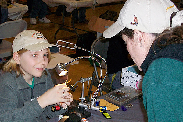 Sam Kenney,11, of Dixmont ties a red, white and blue fly for navy veteran Tina Richard, right, of Clinton at the Cabin Fever Reliever Outdoor Show in Brewer Sunday, Feb. 28, 2010. (Bangor Daily News/John Holyoke) Sam Kenney,11, of Dixmont ties a red, white and blue fly for navy veteran Tina Richard, right, of Clinton at the Cabin Fever Reliever Outdoor Show in Brewer Sunday, Feb. 28, 2010. (Bangor Daily News/John Holyoke)