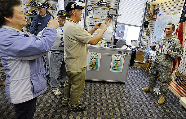 Private First Class (PFC) Daniel Anderson (right) of Portland, Maine proudly held up a "Maine Patriot" vehicle plate as his mom Sue Anderson (far left) of Mars Hill and Maine Troop Greeter Steven Burgess of Newburgh, Maine took his picture Sunday morning. Behind them (left to right) were troop greeters Tom Kohl of Brewer, Larry Bridgham of Bucksport and Darrell McTigue of Dedham. PFC Anderson and fellow soldiers from Fort Carson in Colorado Springs, CO had a layover at Bangor International Airport Sunday morning, March 21, 2010 enroute to their Iraq deployment. Their flight to Bangor brought the troop count flying through BIA to 999,910 and another flight Sunday night is expected to top the one million troop milestone. BANGOR DAILY NEWS PHOTO BY JOHN CLARKE RUSS Private First Class (PFC) Daniel Anderson (right) of Portland, Maine proudly held up a "Maine Patriot" vehicle plate as his mom Sue Anderson (far left) of Mars Hill and Maine Troop Greeter Steven Burgess of Newburgh, Maine took his picture Sunday morning. Behind them (left to right) were troop greeters Tom Kohl of Brewer, Larry Bridgham of Bucksport and Darrell McTigue of Dedham. PFC Anderson and fellow soldiers from Fort Carson in Colorado Springs, CO had a layover at Bangor International Airport Sunday morning, March 21, 2010 enroute to their Iraq deployment. Their flight to Bangor brought the troop count flying through BIA to 999,910 and another flight Sunday night is expected to top the one million troop milestone. BANGOR DAILY NEWS PHOTO BY JOHN CLARKE RUSS