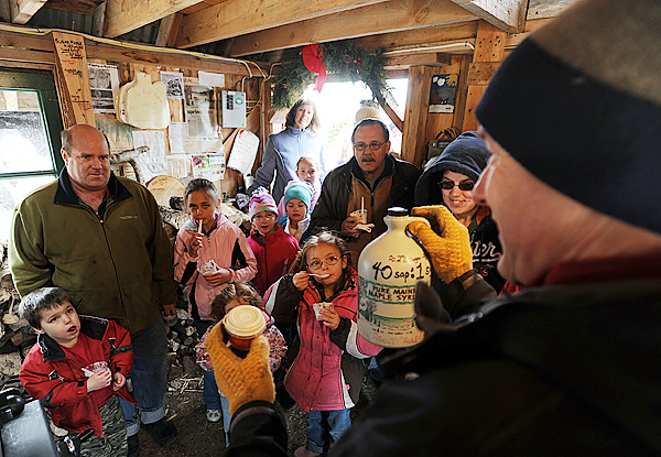Len Price, right, gives a short lecture on how maple syrup is made at his Nutkin Knoll Farm sugar shack in Newburgh on Sunday, March 28, 2010. Visitors to were offered ice cream with maple syrup drizzled on top on Maine Maple Sunday as their questions about how Maine maple syrup is produced were answer by those that tap the trees and boil the sap down. BANGOR DAILY NEWS PHOTO BY KEVIN BENNETT Len Price, right, gives a short lecture on how maple syrup is made at his Nutkin Knoll Farm sugar shack in Newburgh on Sunday, March 28, 2010. Visitors to were offered ice cream with maple syrup drizzled on top on Maine Maple Sunday as their questions about how Maine maple syrup is produced were answer by those that tap the trees and boil the sap down. BANGOR DAILY NEWS PHOTO BY KEVIN BENNETT