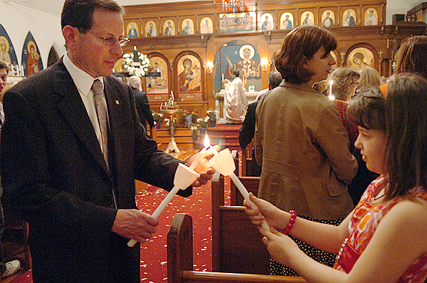 George Leakos (left) helps light the Paschal candle of Elena Speronis, 9, during a midnight mass in celebration of Holy Pascha or Easter at St. George Orthodox Church in Bangor early Sunday morning, April 4, 2010. BANGOR DAILY NEWS PHOTO BY BRIDGET BROWN George Leakos (left) helps light the Paschal candle of Elena Speronis, 9, during a midnight mass in celebration of Holy Pascha or Easter at St. George Orthodox Church in Bangor early Sunday morning, April 4, 2010. BANGOR DAILY NEWS PHOTO BY BRIDGET BROWN