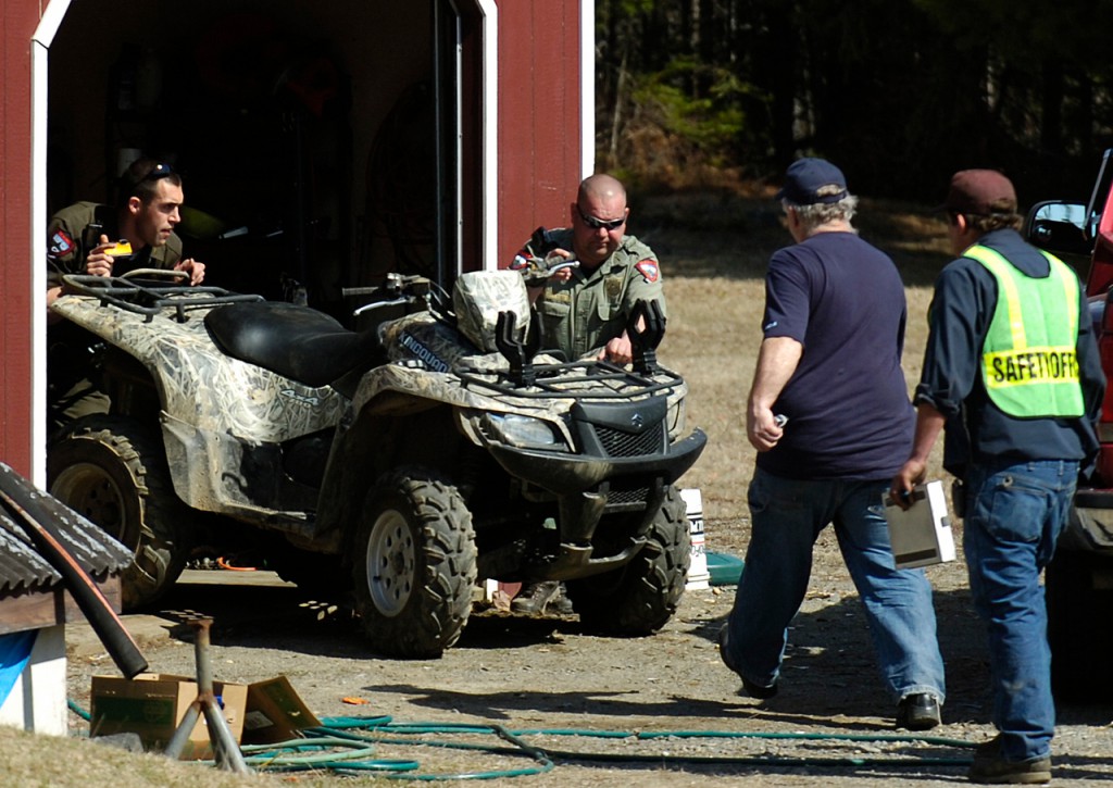 Game Wardens Eric Rudolph, left and Rick Ouellette, center, push a Suzuki King Quad out of a shed for inspection on Monday, April 5, 2010 as Alton fire fighter Maynard Trafton and Lt. Brian Ouelette move in to help. The ATV was crashed by a 15 year-old male from Maryland about 1000 feet this location. The juvenile was not wearing a helmet and was transported to EMMC in Bangor. (Bangor Daily News/Kevin Bennett) Game Wardens Eric Rudolph, left and Rick Ouellette, center, push a Suzuki King Quad out of a shed for inspection on Monday, April 5, 2010 as Alton fire fighter Maynard Trafton and Lt. Brian Ouelette move in to help. The ATV was crashed by a 15 year-old male from Maryland about 1000 feet this location. The juvenile was not wearing a helmet and was transported to EMMC in Bangor. (Bangor Daily News/Kevin Bennett)