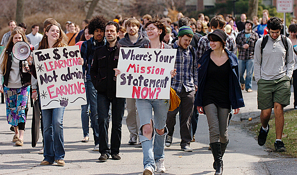 University of Maine students including sophomores Kalie Hess (left with sign) and Libby Shepard (center) lead a march from the steps of Fogler Libriray to Alumni Hall on campus in Orono Wednesday, April 7, 2010 to protest to proposed reductions of academic programs at the University. BANGOR DAILY NEWS PHOTO BY BRIDGET BROWN University of Maine students including sophomores Kalie Hess (left with sign) and Libby Shepard (center) lead a march from the steps of Fogler Libriray to Alumni Hall on campus in Orono Wednesday, April 7, 2010 to protest to proposed reductions of academic programs at the University. BANGOR DAILY NEWS PHOTO BY BRIDGET BROWN