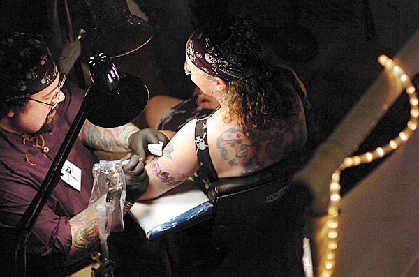 Ed "Wiz" Dumont of Wiz Tattoos in Brewer works on Angella Moser of Jonesboro at the Down East Tattoo Show in Hermon on Saturday, April 10, 2010. "He's been tattooing me for the last 20 years," said Moser of Dumont. The theme of this year's show was "Invasion of Pirates". BANGOR DAILY NEWS PHOTO BY BRIDGET BROWN Ed "Wiz" Dumont of Wiz Tattoos in Brewer works on Angella Moser of Jonesboro at the Down East Tattoo Show in Hermon on Saturday, April 10, 2010. "He's been tattooing me for the last 20 years," said Moser of Dumont. The theme of this year's show was "Invasion of Pirates". BANGOR DAILY NEWS PHOTO BY BRIDGET BROWN