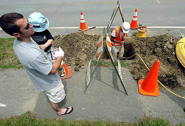 Homeowner Mark Blaine (left) and his son Ethan watch Bangor Gas employee Chris Chambers as he installs natural gas piping under Washington Street in Brewer to connect to Blaine's home. "It's a matter of being able to heat your house for the winter," Blaine said when asked why he's incurring the added expense of converting from oil heat to natural gas. (BANGOR DAILY NEWS PHOTO BY KEVIN BENNETT)
CAPTION
Home owner Mark Blaine, left, and his son Ethan watch Bangor Gas employee Chris Chambers, right, as he installs natural gas piping under Washington Street in Brewer to connect to Blaine's home. "It's a matter of being able to heat your house for the winter," explained Blaine when asked why he's incurring the added expense of converting from oil heat to natural gas. (Bangor Daily News/Kevin Bennett) Homeowner Mark Blaine (left) and his son Ethan watch Bangor Gas employee Chris Chambers as he installs natural gas piping under Washington Street in Brewer to connect to Blaine's home. "It's a matter of being able to heat your house for the winter," Blaine said when asked why he's incurring the added expense of converting from oil heat to natural gas. (BANGOR DAILY NEWS PHOTO BY KEVIN BENNETT)
CAPTION
Home owner Mark Blaine, left, and his son Ethan watch Bangor Gas employee Chris Chambers, right, as he installs natural gas piping under Washington Street in Brewer to connect to Blaine's home. "It's a matter of being able to heat your house for the winter," explained Blaine when asked why he's incurring the added expense of converting from oil heat to natural gas. (Bangor Daily News/Kevin Bennett)