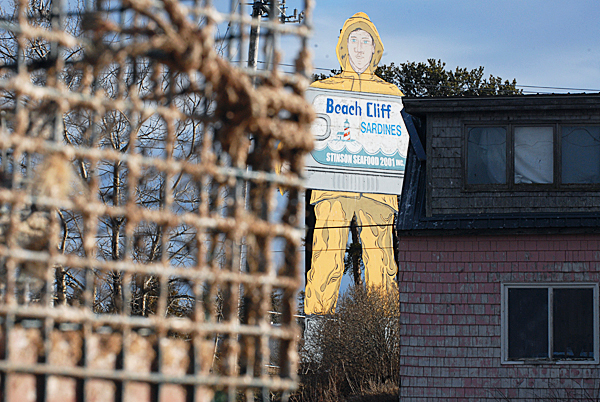 The Beach Cliff Sardine fisherman sign towers over rooftops and lobster traps near the former Stinson Seafood Plant in Prospect Harbor Thursday, February 18, 2010. Bumble Bee Foods, the current plant owner notified employees Wednesday, February 17 that the plant will close in April after being a fixture there for over 100 year. BANGOR DAILY NEWS FILE PHOTO BY JOHN CLARKE RUSS The Beach Cliff Sardine fisherman sign towers over rooftops and lobster traps near the former Stinson Seafood Plant in Prospect Harbor Thursday, February 18, 2010. Bumble Bee Foods, the current plant owner notified employees Wednesday, February 17 that the plant will close in April after being a fixture there for over 100 year. BANGOR DAILY NEWS FILE PHOTO BY JOHN CLARKE RUSS
