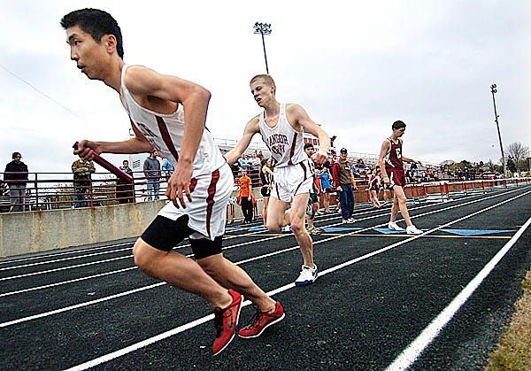 Bangor High School's Juergen Pilot hands the baton to teammate Alex Shi, left, as Shi runs the the third leg of the boys' 4x800 meters during their PVC track meet at Cameron Stadium Friday afternoon, April 23, 2010. Sam Nesbett, Bangor's anchor runner, edged Brewer's Ben Hafford for the team win. BANGOR DAILY NEWS PHOTO BY JOHN CLARKE RUSS Bangor High School's Juergen Pilot hands the baton to teammate Alex Shi, left, as Shi runs the the third leg of the boys' 4x800 meters during their PVC track meet at Cameron Stadium Friday afternoon, April 23, 2010. Sam Nesbett, Bangor's anchor runner, edged Brewer's Ben Hafford for the team win. BANGOR DAILY NEWS PHOTO BY JOHN CLARKE RUSS