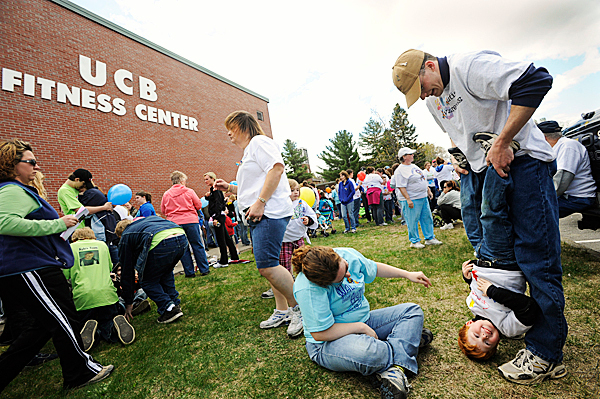 Four-year-old Gabriel Von Kres (cq) of Dexter enjoyed being hung upside-down by his dad Wesley Von Kres as his mom Annie Von Kres (sitting on ground) joined in the fun before the start of Sunday afternoon's Walk for Autism at University College of Bangor. Gabriel was one of many area participants who have autism. His mom and dad said he enjoys handstands, dragons, puppets and yoga. The event, one of several across the state on Sunday, was organized by the Autism Society of Maine to raise money for their childrens summer camp, family retreat weekend, an autism information specialist program and other needs. BANGOR DAILY NEWS PHOTO JOHN CLARKE RUSS Four-year-old Gabriel Von Kres (cq) of Dexter enjoyed being hung upside-down by his dad Wesley Von Kres as his mom Annie Von Kres (sitting on ground) joined in the fun before the start of Sunday afternoon's Walk for Autism at University College of Bangor. Gabriel was one of many area participants who have autism. His mom and dad said he enjoys handstands, dragons, puppets and yoga. The event, one of several across the state on Sunday, was organized by the Autism Society of Maine to raise money for their childrens summer camp, family retreat weekend, an autism information specialist program and other needs. BANGOR DAILY NEWS PHOTO JOHN CLARKE RUSS