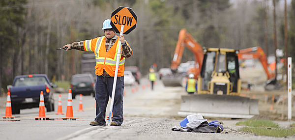 Robbie Lawrence of Bangor, a flagger with Maine Staffing Group's Project Flagging Inc., directs traffic around heavy equipment as road improvement work continued on the Ellsworth stretch of Route 1A Tuesday, April 27, 2010. BANGOR DAILY NEWS PHOTO BY JOHN CLARKE RUSS Robbie Lawrence of Bangor, a flagger with Maine Staffing Group's Project Flagging Inc., directs traffic around heavy equipment as road improvement work continued on the Ellsworth stretch of Route 1A Tuesday, April 27, 2010. BANGOR DAILY NEWS PHOTO BY JOHN CLARKE RUSS
