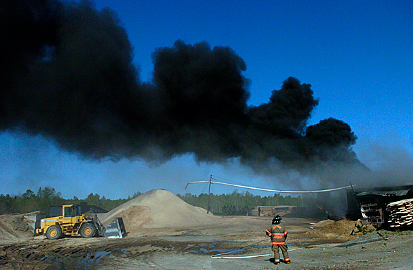 As a large plume of smoke billowed from the site, an Old Town firefighter surveyed the damage as fellow firefighters worked to extinguish the Tuesday morning blaze that destroyed a sawmill at Stillwater Lumber and Building Supplies in Stillwater, Maine. Firefighters from Old Town, Orono, Milford, Alton, Hudson, Bradley, Veazie and Bangor responded to the fire which apparently started in or near a diesel generator which powered the sawmill there. BANGOR DAILY NEWS PHOTO BY JOHN CLARKE RUSS As a large plume of smoke billowed from the site, an Old Town firefighter surveyed the damage as fellow firefighters worked to extinguish the Tuesday morning blaze that destroyed a sawmill at Stillwater Lumber and Building Supplies in Stillwater, Maine. Firefighters from Old Town, Orono, Milford, Alton, Hudson, Bradley, Veazie and Bangor responded to the fire which apparently started in or near a diesel generator which powered the sawmill there. BANGOR DAILY NEWS PHOTO BY JOHN CLARKE RUSS