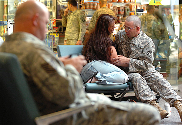 Mike Francis, right, of Old Town, cuddles with a friend at the Bangor International Airport on Thursday, May 13, 2010. Francis, a member of the Maine Army National Guard's 1136th Transportation Company, along with about 170 soliders who stopped at BIA for refueling were greeted by family and friends before their 10-month deployment to Afghanistan. BANGOR DAILY NEWS PHOTO BY KEVIN BENNETT Mike Francis, right, of Old Town, cuddles with a friend at the Bangor International Airport on Thursday, May 13, 2010. Francis, a member of the Maine Army National Guard's 1136th Transportation Company, along with about 170 soliders who stopped at BIA for refueling were greeted by family and friends before their 10-month deployment to Afghanistan. BANGOR DAILY NEWS PHOTO BY KEVIN BENNETT