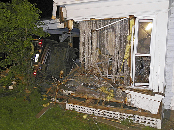 A car rests on its side early Tuesday after crashing through the living room and porch at 254 North Main St. in Pittsfield. Photo courtesy of Peter Hartel A car rests on its side early Tuesday after crashing through the living room and porch at 254 North Main St. in Pittsfield. Photo courtesy of Peter Hartel