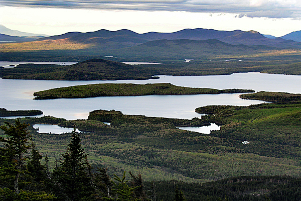 **FILE** Moosehead Lake near Greenville, Maine, is seen in this May 2004 file photo. Maine's Land Use Regulation Commission will meet on Tuesday and Wednesday to discuss Plum Creek Timber Co.'s plans to rezone about 16,000 acres in the Moosehead region. The company wants 975 house lots and has a plan to build two resorts. The plan also includes more than 400,000 acres of land to be conserved through sales and easements that limit future development. (AP Photo/Robert F. Bukaty, files) **FILE** Moosehead Lake near Greenville, Maine, is seen in this May 2004 file photo. Maine's Land Use Regulation Commission will meet on Tuesday and Wednesday to discuss Plum Creek Timber Co.'s plans to rezone about 16,000 acres in the Moosehead region. The company wants 975 house lots and has a plan to build two resorts. The plan also includes more than 400,000 acres of land to be conserved through sales and easements that limit future development. (AP Photo/Robert F. Bukaty, files)