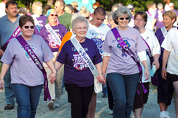 Cancer survivor Susan Oliver of Lee (center), walks hand-in-hand with her daughters Marge Louder of Corinna (left) and Janine Smith of Springfield during the opening lap of the Relay for Life at the Old Town High School track Friday, May 21, 2010. The event continues through today with 84 teams participating to raise money for the American Cancer Society. BANGOR DAILY NEWS PHOTO BY BRIDGET BROWN Cancer survivor Susan Oliver of Lee (center), walks hand-in-hand with her daughters Marge Louder of Corinna (left) and Janine Smith of Springfield during the opening lap of the Relay for Life at the Old Town High School track Friday, May 21, 2010. The event continues through today with 84 teams participating to raise money for the American Cancer Society. BANGOR DAILY NEWS PHOTO BY BRIDGET BROWN