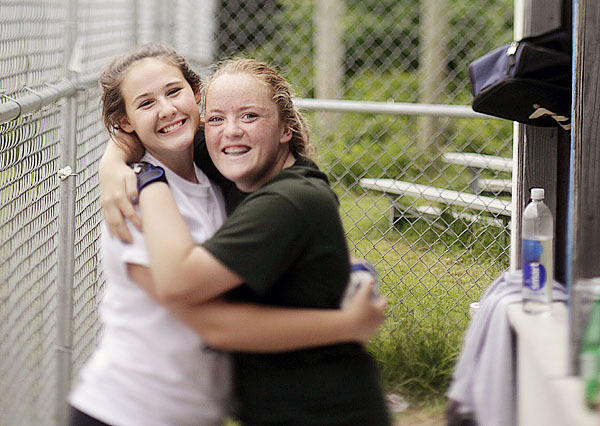 Mariners' players Sydney Ouzts, left, and Abby Grindle ham it up while waiting their at-bat during practice Monday, June 14, Deer Isle, Maine. (Bangor Daily News/Michael C. York) Mariners' players Sydney Ouzts, left, and Abby Grindle ham it up while waiting their at-bat during practice Monday, June 14, Deer Isle, Maine. (Bangor Daily News/Michael C. York)