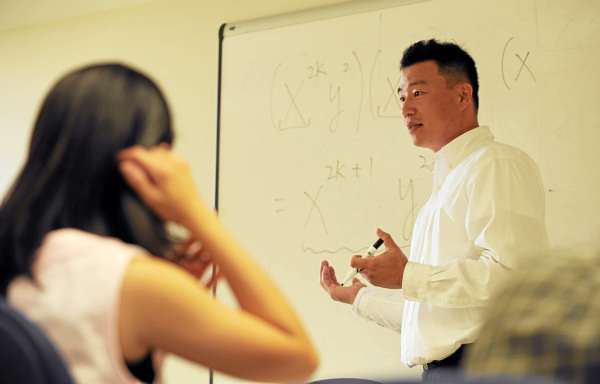 Eastern Maine Community College mathematics instructor Changsu Lee teaches an intermediate algebra class, which includes several international students, at the Bangor college on Wednesday, June 30, 2010. Lee has developed an Integrative English Training Program at EMCC, which helps foreign students learn English quickly while they still take courses in their chosen fields of study. (Bangor Daily News/Kevin Bennett) Eastern Maine Community College mathematics instructor Changsu Lee teaches an intermediate algebra class, which includes several international students, at the Bangor college on Wednesday, June 30, 2010. Lee has developed an Integrative English Training Program at EMCC, which helps foreign students learn English quickly while they still take courses in their chosen fields of study. (Bangor Daily News/Kevin Bennett)
