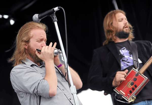 Dustin Arbuckle, left, plays harmonica as Aaron Moreland, right, plays a hand crafted cigar box guitar during the afternoon set of the North Altantic Blues Festival on Sunday, July 1, 2010 in Rockland. The pair of bluesmen from Kansas claim they drove 16 hours over night to get to the two day event. (Bangor Daily News/Kevin Bennett) Dustin Arbuckle, left, plays harmonica as Aaron Moreland, right, plays a hand crafted cigar box guitar during the afternoon set of the North Altantic Blues Festival on Sunday, July 1, 2010 in Rockland. The pair of bluesmen from Kansas claim they drove 16 hours over night to get to the two day event. (Bangor Daily News/Kevin Bennett)