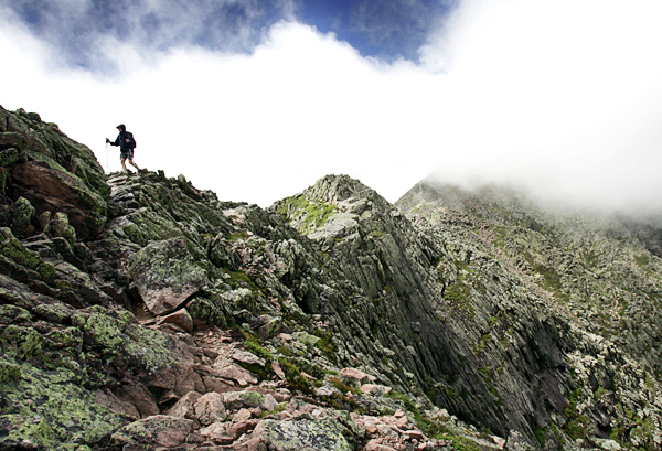 A hiker makes his way across the Knife Edge, a narrow serrated ridge leading to the summit of Mount Katahdin during the summer of 2006. Only one trail to the top of the mountain will be open for this year's Memorial Day weekend, officials say. Baxter STate Park Director Jensen Bissell decided to open Abol Trail after a hike on Friday morning. Other trails will open once conditions improve. (AP Photo/Robert F. Bukaty/FILE) A hiker makes his way across the Knife Edge, a narrow serrated ridge leading to the summit of Mount Katahdin during the summer of 2006. Only one trail to the top of the mountain will be open for this year's Memorial Day weekend, officials say. Baxter STate Park Director Jensen Bissell decided to open Abol Trail after a hike on Friday morning. Other trails will open once conditions improve. (AP Photo/Robert F. Bukaty/FILE)