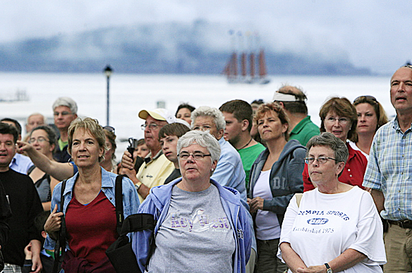 Tourists and locals wait to catch a glimpse of President Barack Obama who was dining with his family at a waterfront restaurant, Friday, July 16, 2010, in Bar Harbor, Maine. In the background a four-masted schooner sails by a foggy island. (AP Photo/Robert F. Bukaty) Tourists and locals wait to catch a glimpse of President Barack Obama who was dining with his family at a waterfront restaurant, Friday, July 16, 2010, in Bar Harbor, Maine. In the background a four-masted schooner sails by a foggy island. (AP Photo/Robert F. Bukaty)