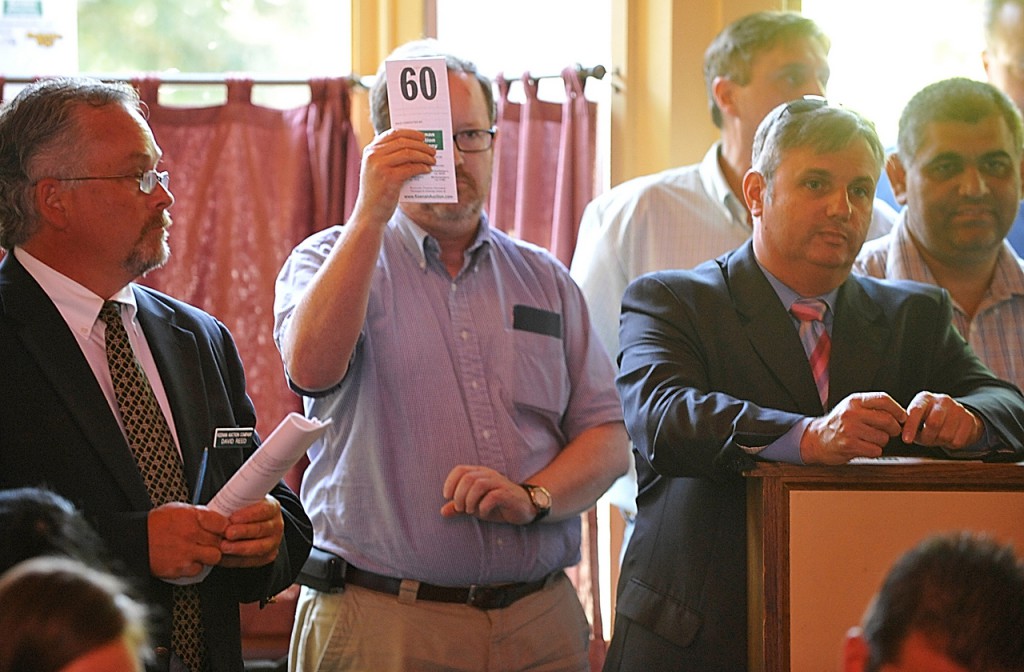 A bidder raises his card during Wednesday's real estate auction of the Whig & Courier's restaurant facilty and equipment. Dan Sykes of Bangor had the highest bid at $355,000. (Bangor Daily News/John Clarke Russ) A bidder raises his card during Wednesday's real estate auction of the Whig & Courier's restaurant facilty and equipment. Dan Sykes of Bangor had the highest bid at $355,000. (Bangor Daily News/John Clarke Russ)