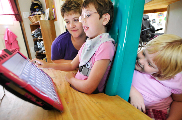 (BANGOR DAILY NEWS PHOTO BY JOHN CLARKE RUSS)
CAPTION
Nine-year-old Madyson Gray (cq), 9 works on her communication skills with the help of an augmentative communication laptop computer as her mother Tracy Gray, left, and Madyson's sister Morgan Gray,right, 6, look on at the family's home in Winterport Monday, July 19, 2010. Madyson has mitochondrial myopathy, a degenerative neuromuscular disease that has affected her motor and communication skills. (Bangor Daily News/John Clarke Russ) (BANGOR DAILY NEWS PHOTO BY JOHN CLARKE RUSS)
CAPTION
Nine-year-old Madyson Gray (cq), 9 works on her communication skills with the help of an augmentative communication laptop computer as her mother Tracy Gray, left, and Madyson's sister Morgan Gray,right, 6, look on at the family's home in Winterport Monday, July 19, 2010. Madyson has mitochondrial myopathy, a degenerative neuromuscular disease that has affected her motor and communication skills. (Bangor Daily News/John Clarke Russ)