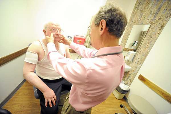 Dr. Eric Hartz, a medical oncologist and chief medical information officer at EMMC, checks for lymph node swelling on Doug Villone (left) of Monson. Villone was diagnosed last year with a rare and aggressive testicular lymphoma. Dr. Hartz, a medical oncologist, informed Villone that he was in remission during this visit to the Lafayette Family Cancer Center in Brewer, Maine May 17, 2010. BANGOR DAILY NEWS PHOTO JOHN CLARKE RUSS Dr. Eric Hartz, a medical oncologist and chief medical information officer at EMMC, checks for lymph node swelling on Doug Villone (left) of Monson. Villone was diagnosed last year with a rare and aggressive testicular lymphoma. Dr. Hartz, a medical oncologist, informed Villone that he was in remission during this visit to the Lafayette Family Cancer Center in Brewer, Maine May 17, 2010. BANGOR DAILY NEWS PHOTO JOHN CLARKE RUSS