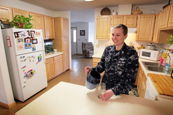 In this photo taken March 3, 2010, Autumn Swarts chats with a guest at her military housing at Brunswick Naval Air Base in Brunswick, Maine. Swats, a command career counselor, says she'll miss the niceties of her home, which includes radiant heat floors, when she leaves Brunswick. The base is scheduled to close in the upcoming months. (AP Photo/Robert F. Bukaty) In this photo taken March 3, 2010, Autumn Swarts chats with a guest at her military housing at Brunswick Naval Air Base in Brunswick, Maine. Swats, a command career counselor, says she'll miss the niceties of her home, which includes radiant heat floors, when she leaves Brunswick. The base is scheduled to close in the upcoming months. (AP Photo/Robert F. Bukaty)