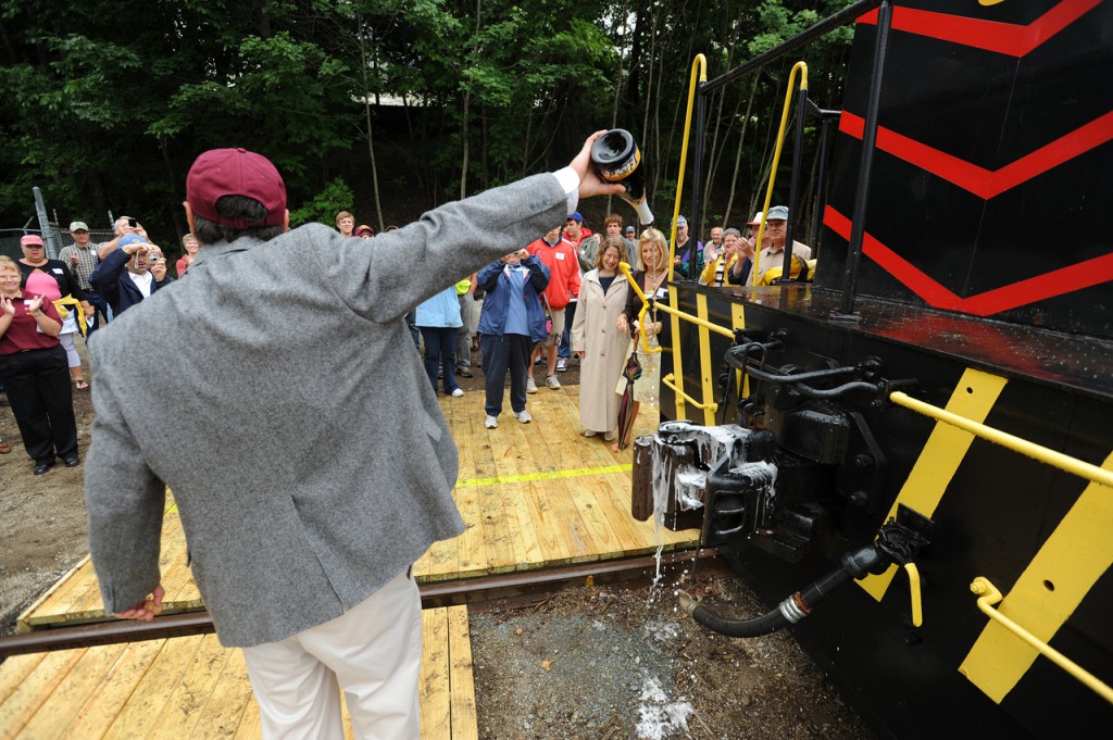 "May God bless this train and all who ride on it." said Downesat Rail Heritage Preservation Trust President Thomas Testa as her poured champagne over the #54 locomotive's coupling prior to the maiden run of the Downeast Scenic Railroad on Saturday, July 24, 2010 in Ellsworth. (Bangor Daily News/Kevin Bennett) "May God bless this train and all who ride on it." said Downesat Rail Heritage Preservation Trust President Thomas Testa as her poured champagne over the #54 locomotive's coupling prior to the maiden run of the Downeast Scenic Railroad on Saturday, July 24, 2010 in Ellsworth. (Bangor Daily News/Kevin Bennett)