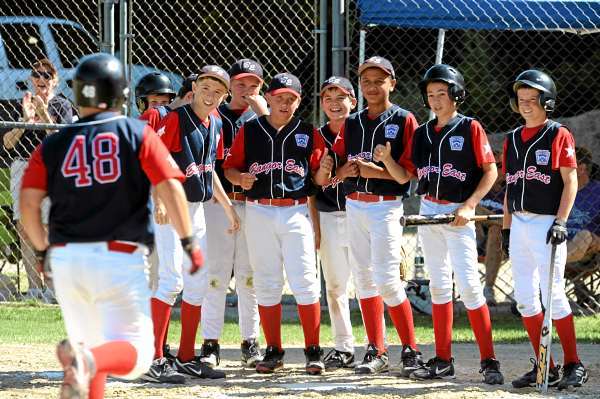 The Bangor East Little League team waits at homne plate for Tyler Mallory-MacDonald after he hit a home run during the 3rd inning in Hampden against Camden-Rockport on Tuesday, July 27, 2010. (Bangor Daily News/Kevin Bennett) The Bangor East Little League team waits at homne plate for Tyler Mallory-MacDonald after he hit a home run during the 3rd inning in Hampden against Camden-Rockport on Tuesday, July 27, 2010. (Bangor Daily News/Kevin Bennett)