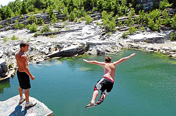 Ricky Palmer, 18, (left) of Winterport watches as Nick Adams, 16, of Frankfort jumps off a ledge at the Mt. Waldo Quarry on Sunday, Aug. 1, 2010, a popular swimming hole where a woman died Saturday. Amy Willey, 39, of Bucksport was killed when she jumped from a similar ledge and failed to resurface. "I hope they don't shut it down," Adams said in between jumps Sunday. "We swim up here all the time, all summer." (Bangor Daily News/Bridget Brown) Ricky Palmer, 18, (left) of Winterport watches as Nick Adams, 16, of Frankfort jumps off a ledge at the Mt. Waldo Quarry on Sunday, Aug. 1, 2010, a popular swimming hole where a woman died Saturday. Amy Willey, 39, of Bucksport was killed when she jumped from a similar ledge and failed to resurface. "I hope they don't shut it down," Adams said in between jumps Sunday. "We swim up here all the time, all summer." (Bangor Daily News/Bridget Brown)