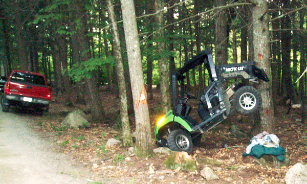 An Arctic Cat RTV with a dump bucket that was being driven by Tasha Barnes, 20, of Baileyville rests on a hemlock tree. Miss Barnes and two passengers were injured in the incident Saturday evening, August 15, 2010 in Danforth. (Photo Credit: Maine Warden Service) An Arctic Cat RTV with a dump bucket that was being driven by Tasha Barnes, 20, of Baileyville rests on a hemlock tree. Miss Barnes and two passengers were injured in the incident Saturday evening, August 15, 2010 in Danforth. (Photo Credit: Maine Warden Service)
