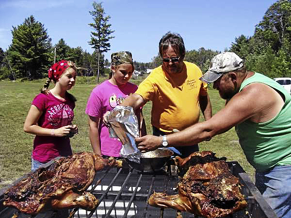 The Harmony community turned out in force Sunday to party with Caitlin McKenney of Harmony, who had a kidney removed because of a cancerous tumor and is now receiving chemotherapy. A pig roast and a free concert by Jillian Cardarelli and her band of Haverhill, Mass. were held as a fund-raising event. Helping to roast the pigs were from left: Erica Lommel, Madison Chadbourne, Jeff Chadbourne and Darren Huff. (Bangor Daily News Photo by Diana Bowley) The Harmony community turned out in force Sunday to party with Caitlin McKenney of Harmony, who had a kidney removed because of a cancerous tumor and is now receiving chemotherapy. A pig roast and a free concert by Jillian Cardarelli and her band of Haverhill, Mass. were held as a fund-raising event. Helping to roast the pigs were from left: Erica Lommel, Madison Chadbourne, Jeff Chadbourne and Darren Huff. (Bangor Daily News Photo by Diana Bowley)